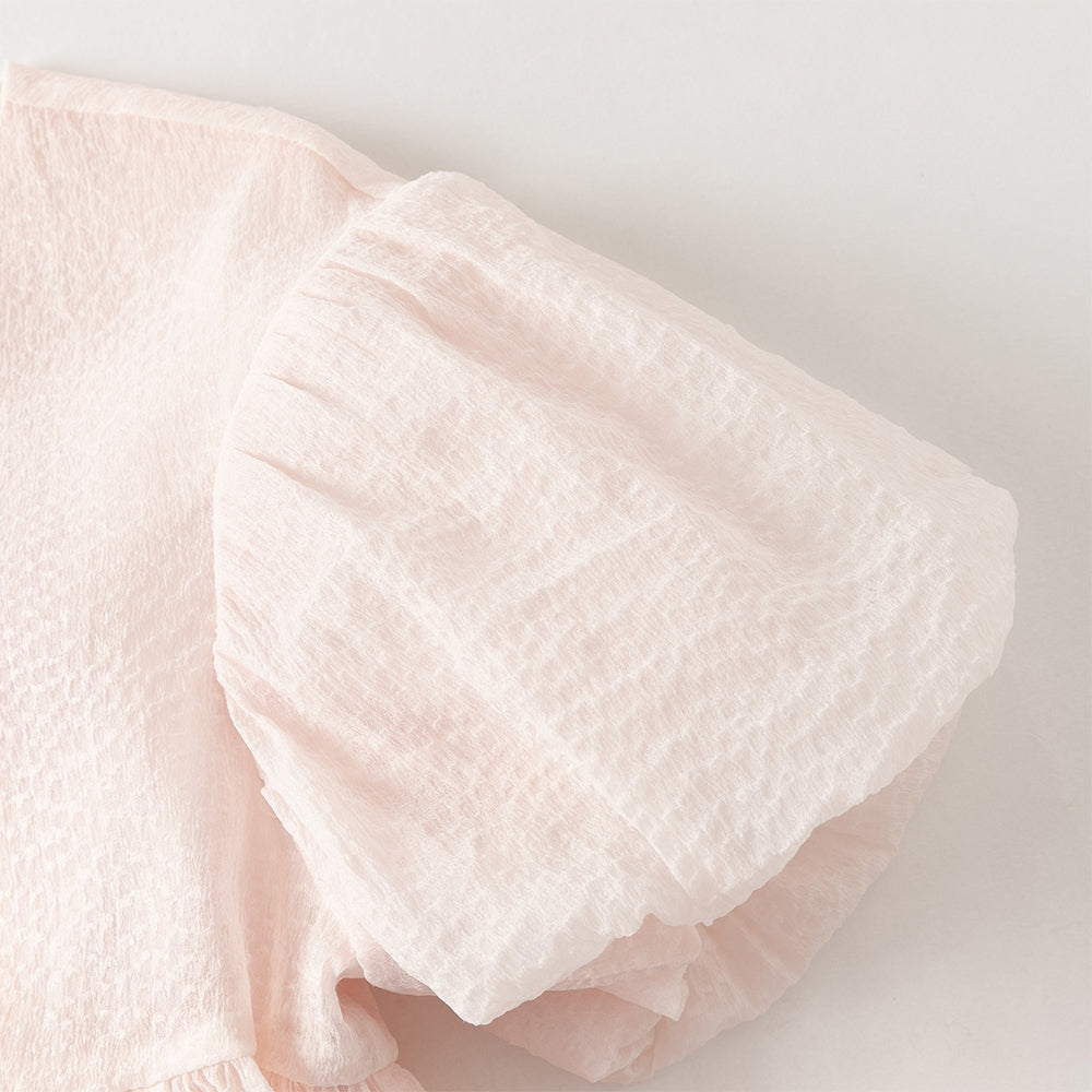 فستان بنات صيفي وردي فاتح بياقة دائرية وأكمام منفوشة من قماش محبك (ملمس بارز) بأسلوب أميرة